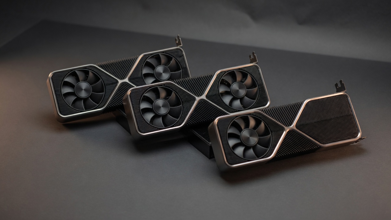 Studio photograph of three pre-owned NVIDIA Founders Edition graphics cards on a charcoal surface